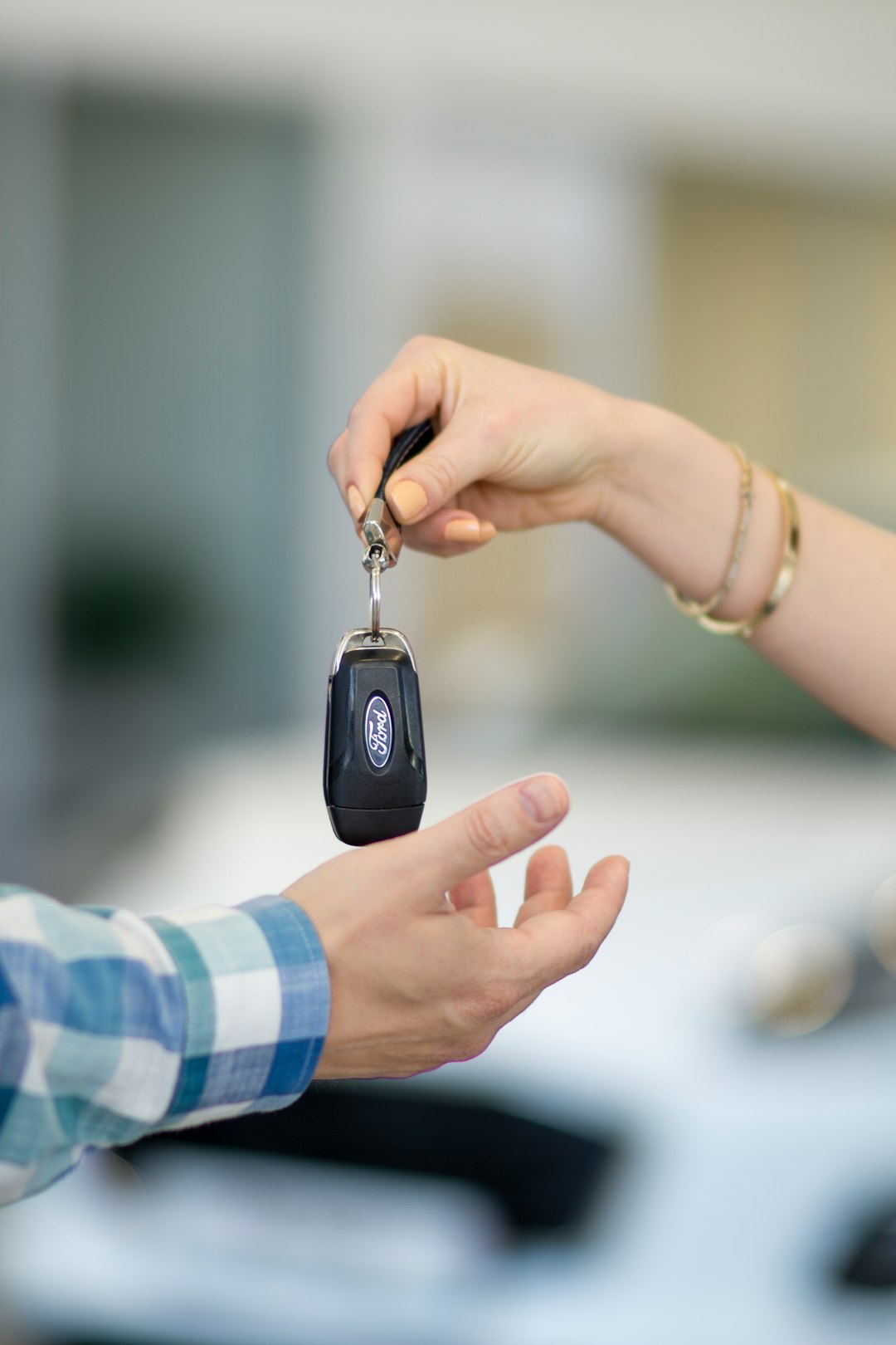 Home a-person-handing-a-car-key-to-another-person-aboff2gxb-0